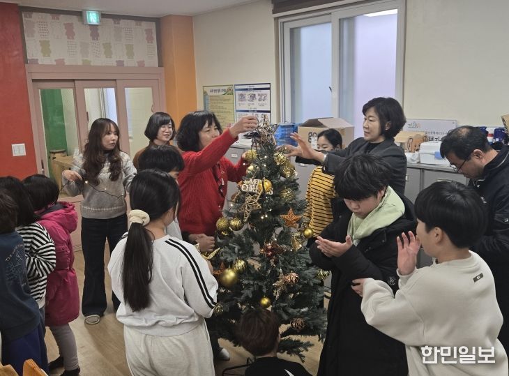 금산다락원 직원들이 사랑호크마지역아동센터 아동들과 크리스마스트리를 만들고 있다.